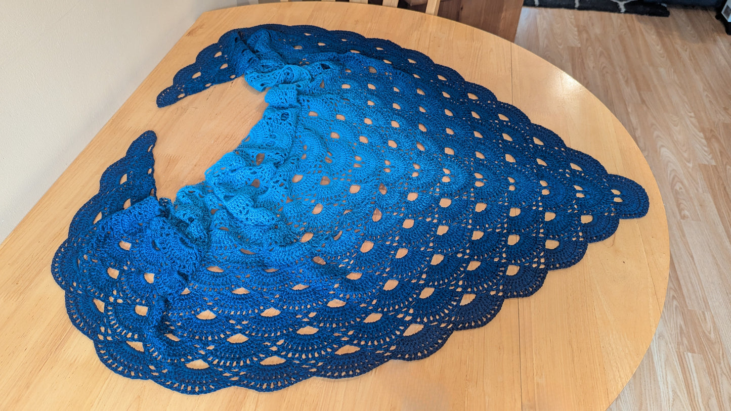 Blue gradient shawl on a wooden table