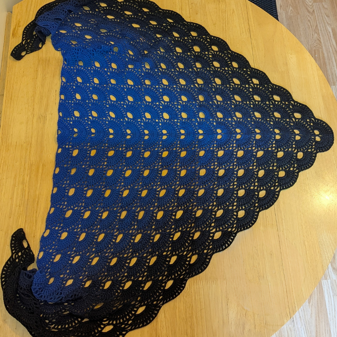 Blue and black shawl on a wooden surface