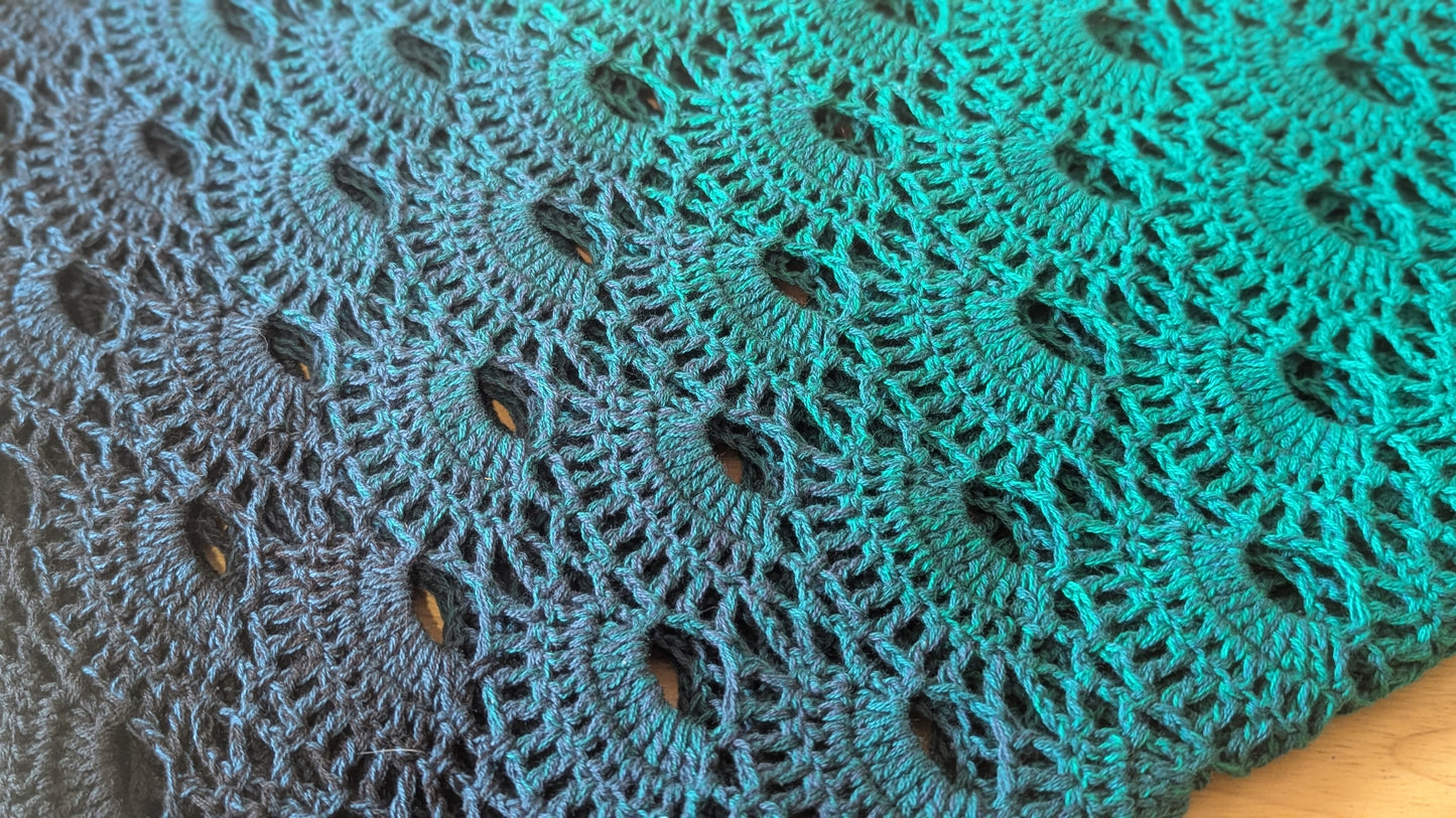 Close-up of a green crocheted shawl